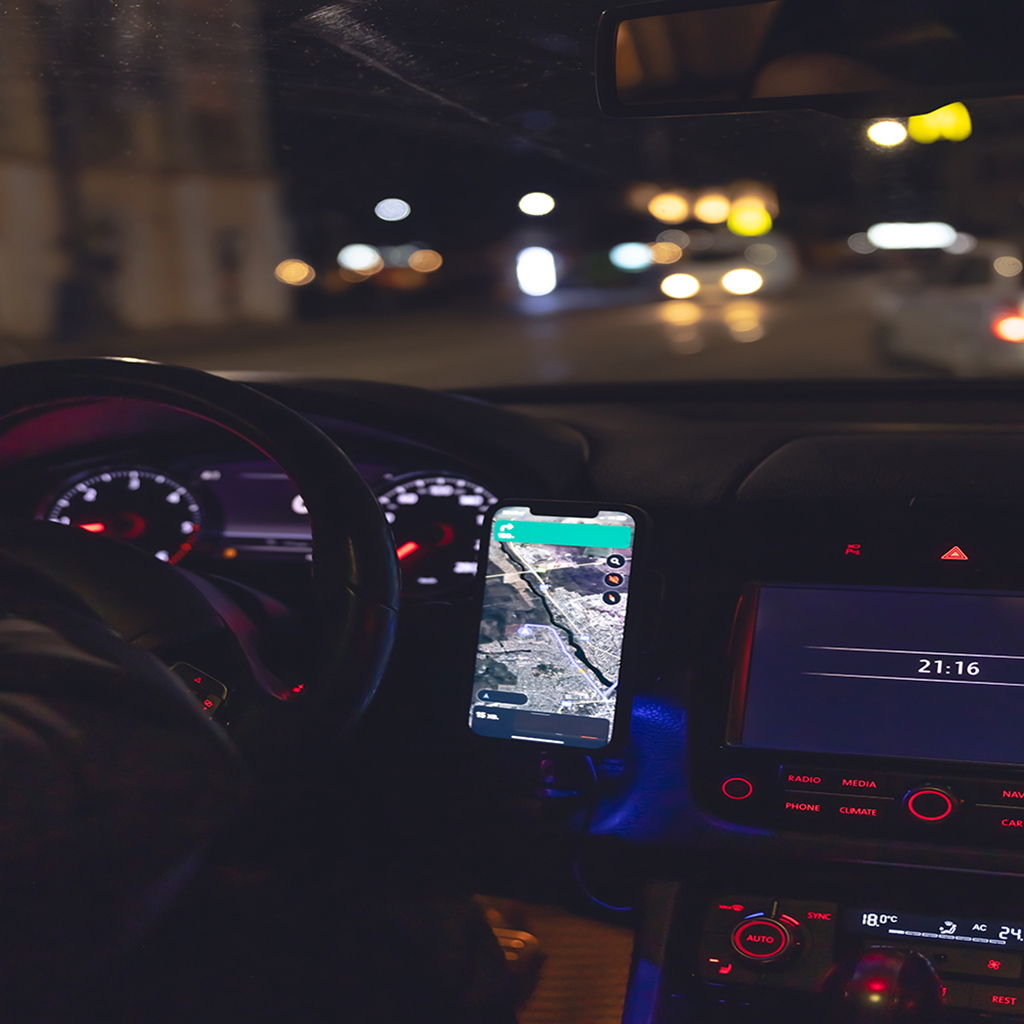 navigator in a smartphone in a car at night, close up.